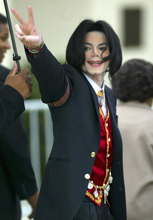 Pop star Michael Jackson flashes a peace sign to his supporters while arriving at the courthouse in 